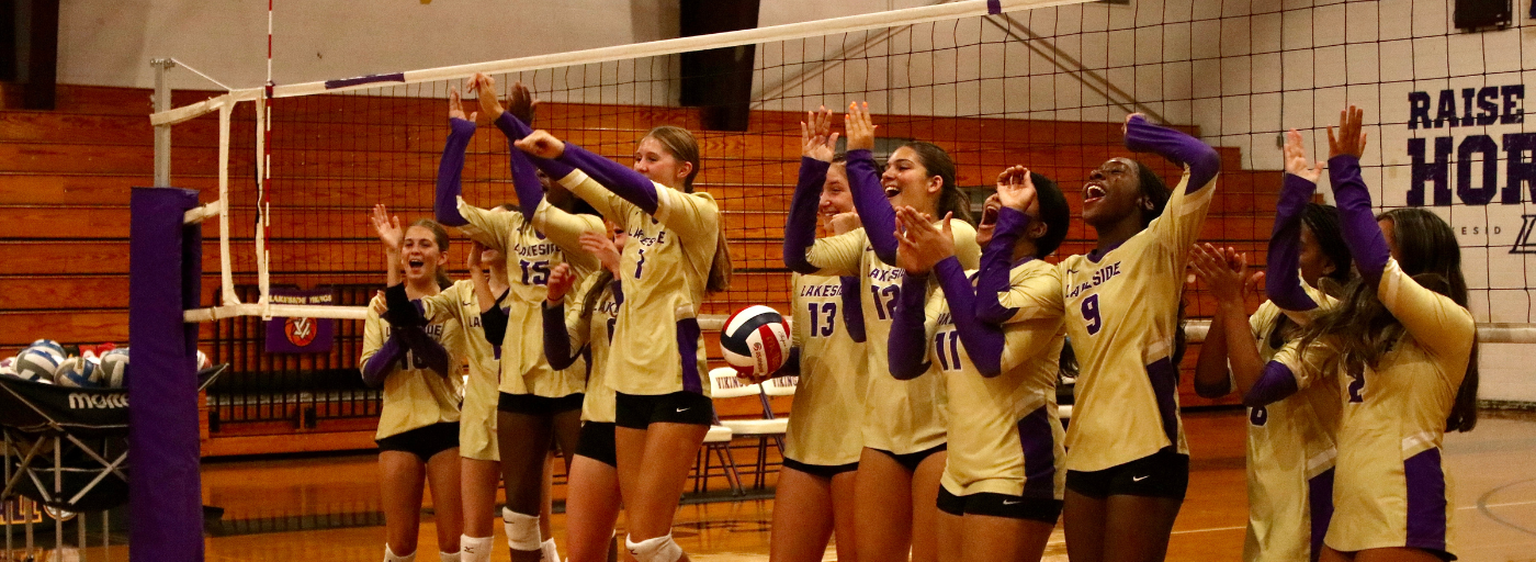 Lakeside volleyball team at net. 